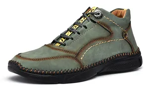 Detailed view of grey-green outdoor casual leather shoe with stitching and yellow straps.