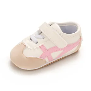 Soft sole baby walking shoes in white and pink design with adjustable Velcro strap