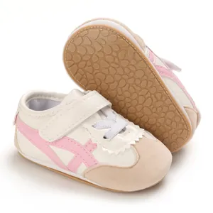 Classic infant walking sneakers with pink stripes and soft non-slip tan rubber soles