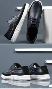 Detailed view of navy leather casual shoes with thick white soles and orange stitching.