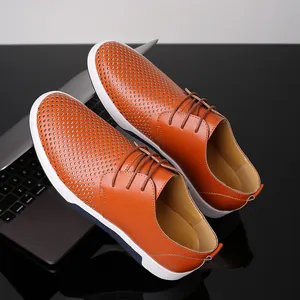 Men's orange perforated leather sneakers with breathable laser-cut design and white sole