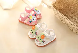 Two pairs of cute baby sandals in pink and white with bunny and flower motifs.