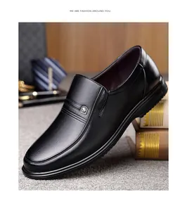 Side view of premium black genuine leather business loafers with a slip-on design.