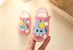 Detailed view of pink infant girl sandals featuring a cute blue cartoon rabbit