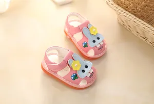 Detail of pink baby girls' walking sandals with cute cartoon rabbit design