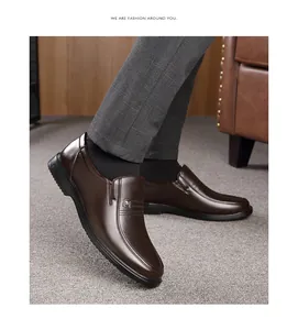 Detailed view of men's brown genuine leather business casual loafers worn with suit
