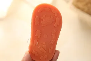 Detailed close-up view of orange non-slip sole with cartoon cow and size 15 engraving