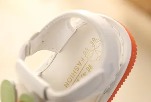 Macro detail view showing the soft cushioned insole of white infant walking sandals