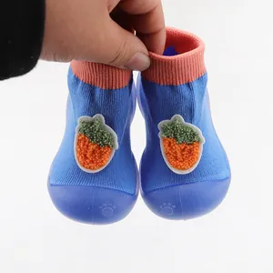 Detail view of breathable blue baby sock shoes with soft rubber soles and carrot patch.