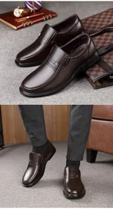 Detailed view of men's brown leather business casual loafers on feet and as a pair.