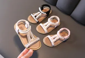 Detailed view of girls' Roman sandals with pearls and glitter in multiple colors