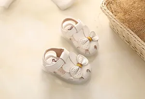 Detailed view of cream toddler girls sandals featuring cute bunny ears and bow decoration