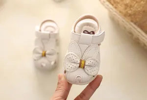 Close-up of white baby princess sandals featuring elegant bow and closed-toe design for infants