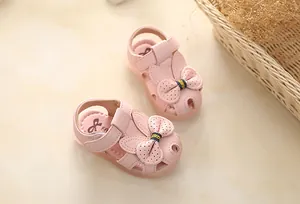Close-up of pink toddler girls' sandals with cute bow decoration and soft sole