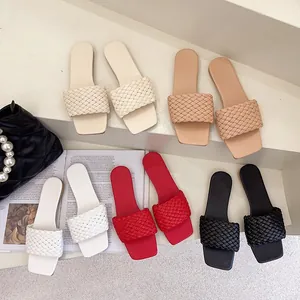 Detailed view of women's flat woven slide sandals in multiple stylish summer colors