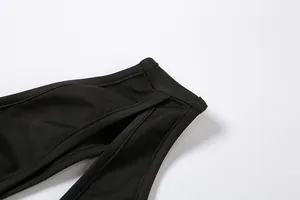Close-up detail view of the sexy cut-out shoulder design on a black women's bodysuit