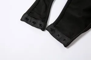 Detail shot of black slim-fit bodysuit featuring adjustable bottom snap button closures