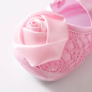 Gedetailleerd macrozicht op een roze prinsessenschoen voor baby's met een grote satijnen roos