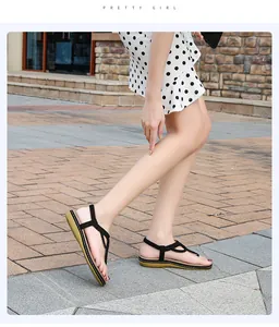 Outdoor detail shot of stylish black bohemian braided strap thong sandals for women's summer