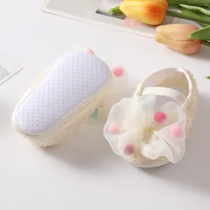 Detailed view of baby princess shoes with non-slip soles and colorful bow decoration