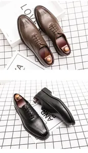 Detailed view of brown and black men's pointed toe business casual leather shoes.