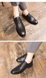 Close-up detail of men's black leather business casual shoes with pointed toe design.