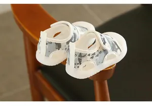 Detail of breathable baby mesh sandals with closed toe and soft white rubber sole.