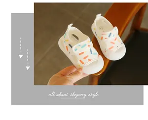 Close-up of white breathable mesh baby sandals featuring colorful dash patterns and soft soles