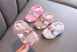 Detailansicht von weichen Sommersandalen für Babymädchen mit glitzernder Schleife