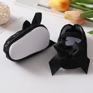 Close-up of black baby princess shoes with large bows and anti-slip soft soles