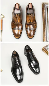 Detail von klassischen britischen Brogue-Oxfords in poliertem Schwarz und Braun.