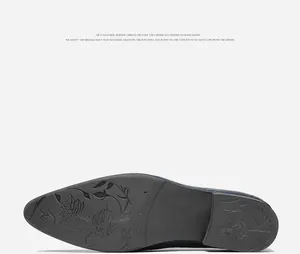Detailed view of men's leather shoe outsole featuring embossed floral rose patterns