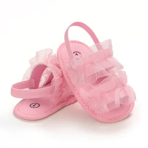 Detailed view of pink baby sandals featuring soft soles and mesh ruffle lace design
