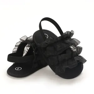 Detailed macro view showing the black mesh ruffles of these soft sole baby sandals