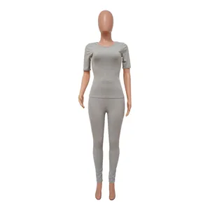 Full front view of a grey ribbed two-piece athletic set including top and leggings
