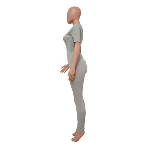 Close-up side view of a grey ribbed two-piece high-stretch athletic set for women