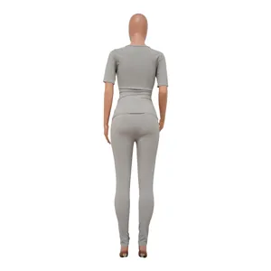 Back view of women's gray ribbed two-piece athletic set on a mannequin, highlighting texture