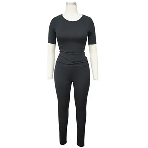 Detail view of black ribbed two-piece sports set with short sleeves and leggings.