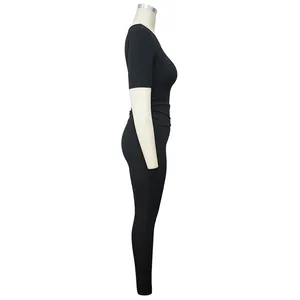 Side view detail showing the fit of a black high-stretch ribbed two-piece athletic yoga set
