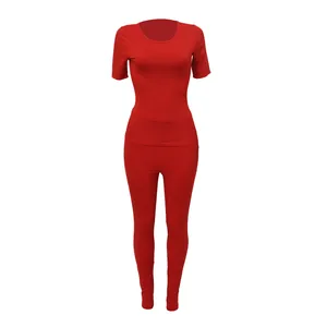 Red ribbed two-piece athletic set with short sleeve top and leggings for women.