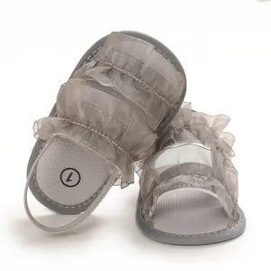 Detailed view of grey mesh ruffles on baby girl soft-sole sandals for summer