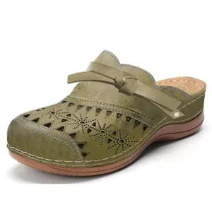 Elegant olive green laser-cut closed-toe flat sandals with decorative bow strap detail
