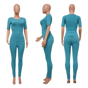 Peacock blue ribbed high-stretch two-piece sports set shown from front, side and back angles.