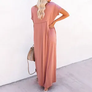 Back view of a solid dusty rose loose maxi dress showing elegant draped fabric on a model