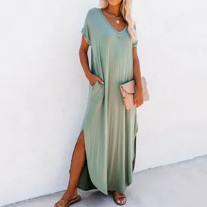 Detail view of a loose sage green maxi dress with side slits and convenient side pockets
