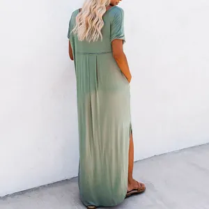 Rear view of a sage green loose maxi dress showing soft drape and side slit detail