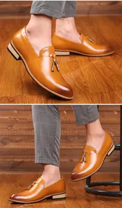 Close-up of brown leather tassel loafers with pointed toe and elegant British style