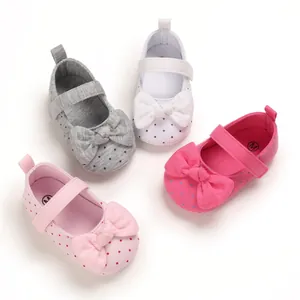 Detailed view of baby girl soft sole walker shoes with polka dots and bows in multiple colors