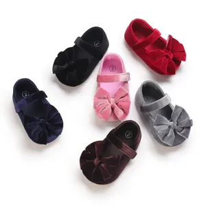 Detailed view of colorful soft velvet baby Mary Jane shoes with large decorative bows