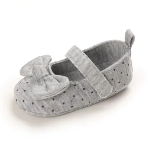 Detail view of grey polka dot baby girl princess walker shoe with soft sole and bow